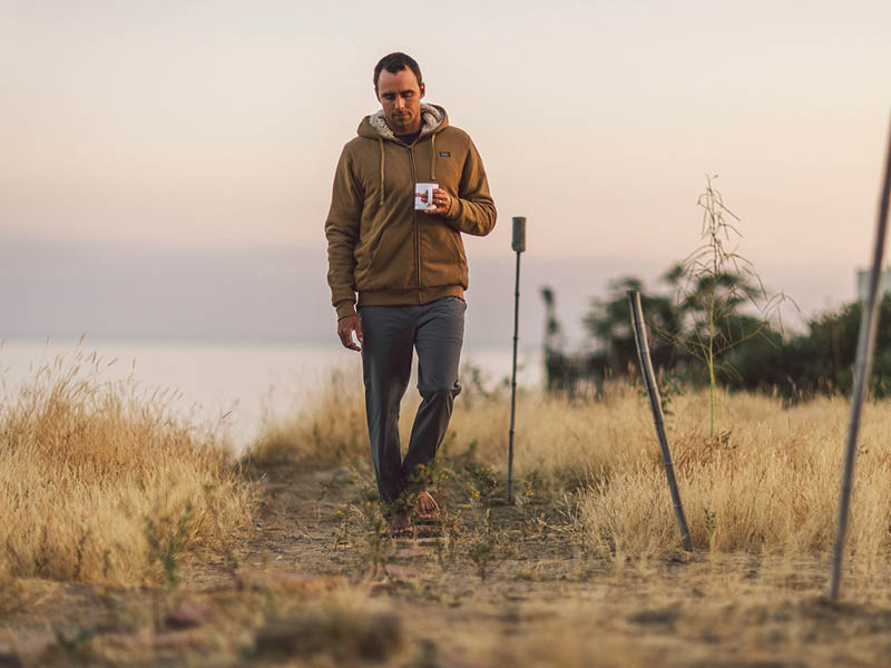 Sippin&#39; some coffee, wearing a hoodie, on a gloomy morning at the beach.